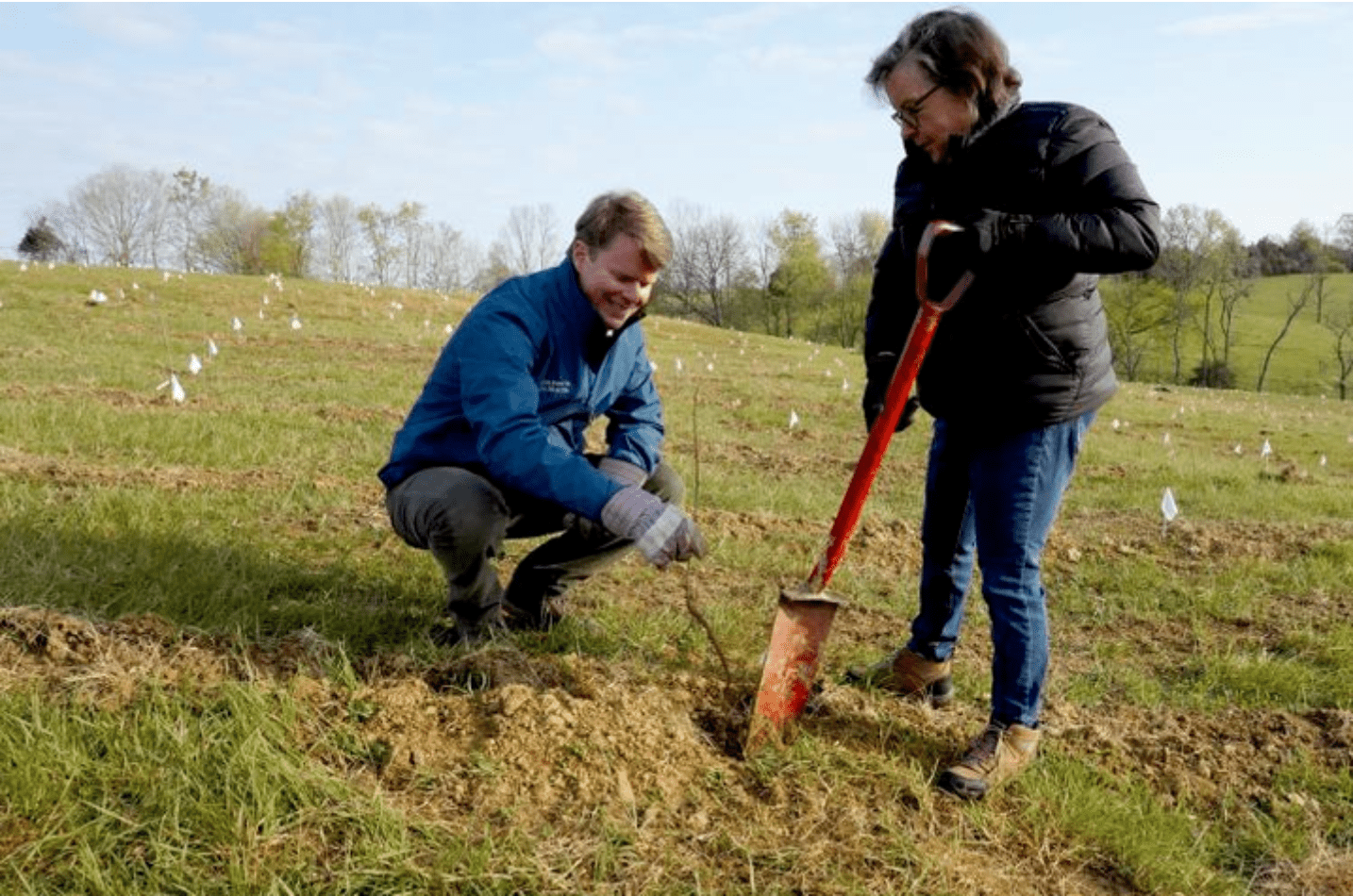 Image of Rob Samuels and a woman planting trees at Maker's Mark
