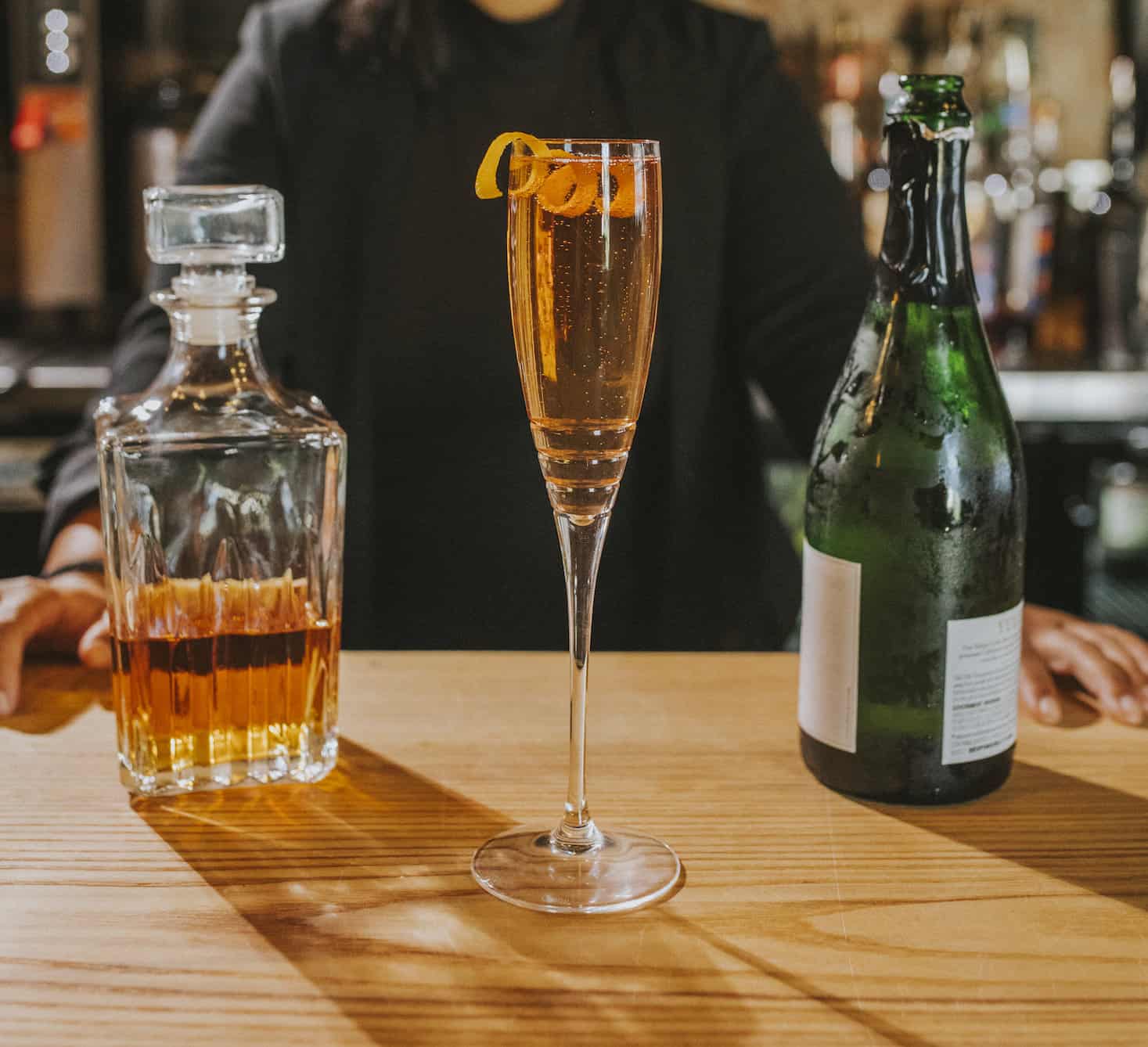 Seelbach cocktail in a champagne flute with an orange twist