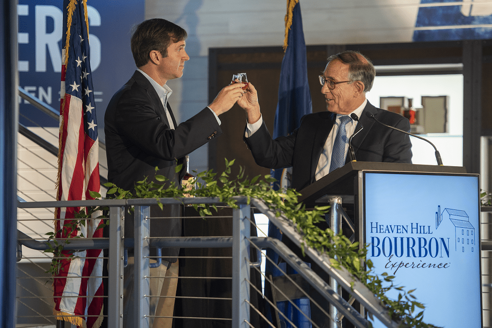 Governor Andy Beshear cheersing Heaven Hill President Max Shapira at their ribbon cutting ceremony