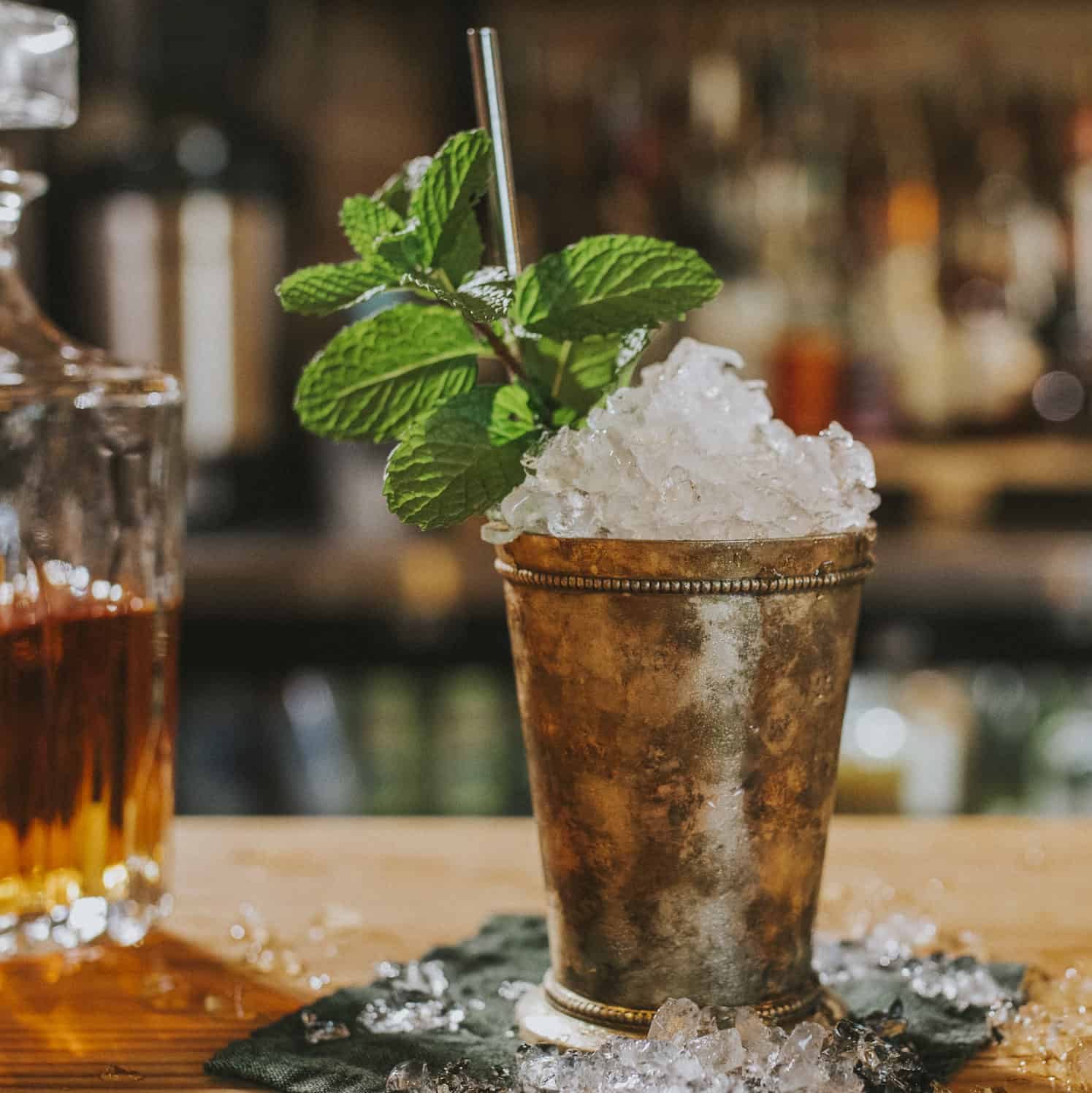 mint julep in a frosty silver cup on a bar