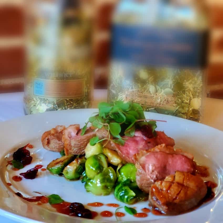Dish of duck breast with old fashioned gastrique and brussel sprouts